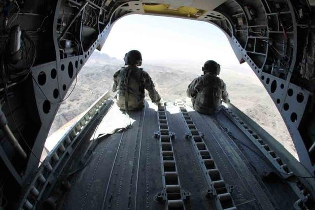 Soldiers sit on the rear deck of a CH-47 Chinook helicopter while flying over southern Afghanistan Oct. 19, 2010. (Cpl. Robert Thaler/U.S. Army photo)